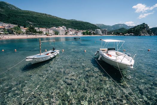 Old fishing boats in clear water in Montenegro
