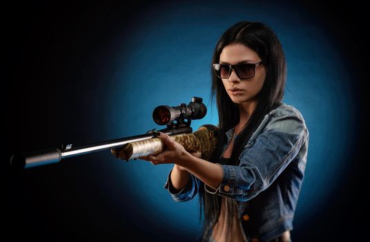 a girl in a denim jacket with a sniper rifle