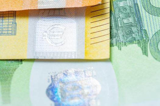Colorful Euro Banknote, Orange fifty Euro, Yellow 200 Euro and green one hundred Euro bills. Closeup of Euro Bills. Hologram reflecting Light