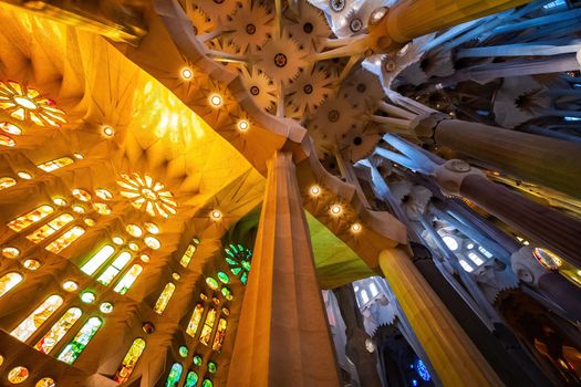 BARCELONA, SPAIN - MARCH 3, 2019: CColorful interior of Sagrada Familia. The cathedral designed by Gaudi.