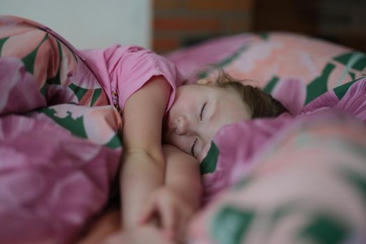 Little girl kid sleeping sweetly in bed