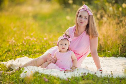 mother and daughter in matching pink dresses