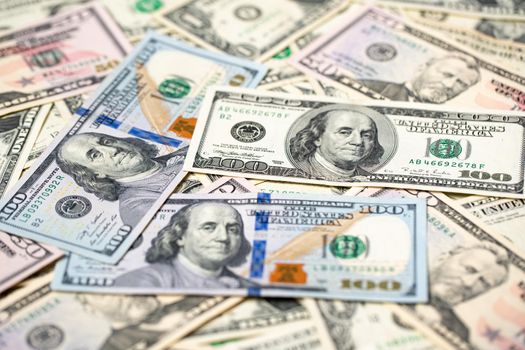 One hundred dollar banknotes as background. Spread out dollar bills, paper money, one hundred dollar bills with president Benjamin Franklin.