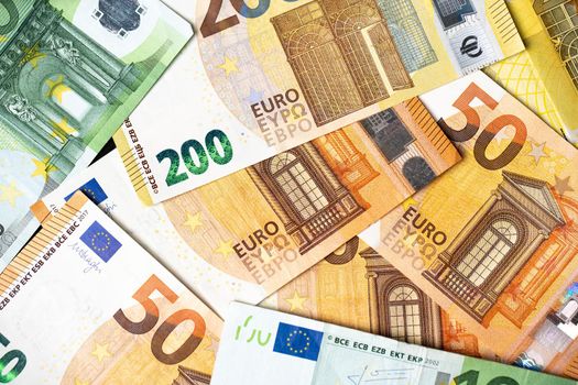 Euro banknotes as background, fifty, one hundred and two hundred euro bills, paper money. European monetary union currency