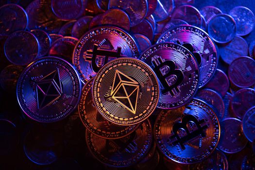Ethereum on piled up Dollar coins and Bitcoin cryptocurrency coin