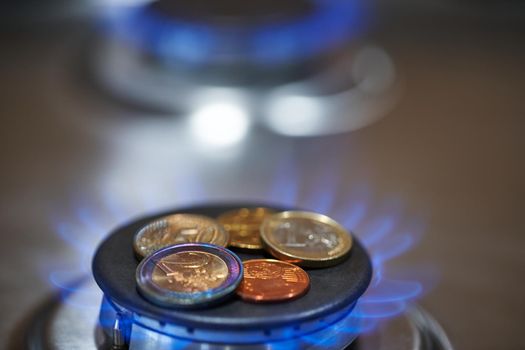 Euro coins on burning stove. Natural Gas Price concept