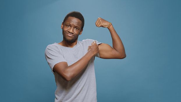 Athletic person flexing biceps and triceps muscles on camera