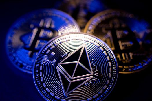 Ethereum Coin and Bitcoin in background. Cryptocurrency ETH and BTC. Tokens Blockchain. High Tech Crypto concept. Decentralized crypto currency Ether