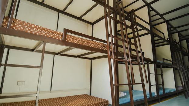 Three-story beds in a budget Asian hostel.