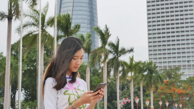 Vietnamese girl talking on the phone. Danang city