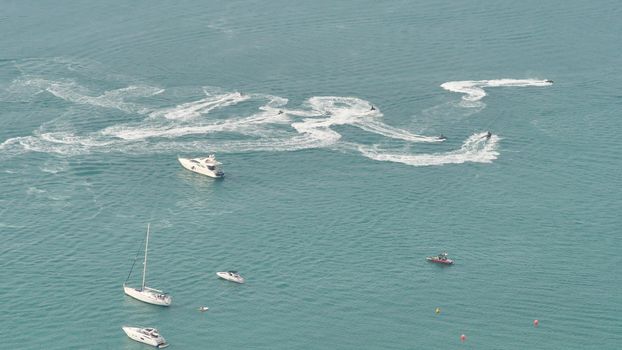 Boats swim and leave trails around Dubai.