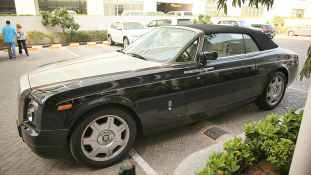 DUBAI, UAE - AUGUST 20, 2014: Black Rolls Royce on Dubai Street. UAE.