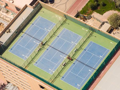 Three tennis courts on the roof of a building in Dubai.