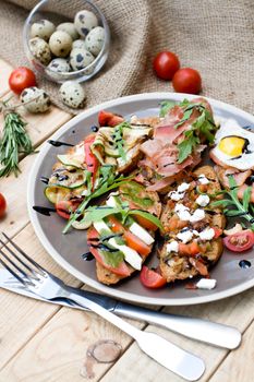 Many delicious bruschetta with cheese, tomato, quail egg, ham, salmon, roasted vegetables and herbs