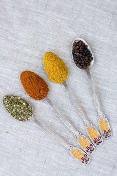 Assortment of powder spices on spoons