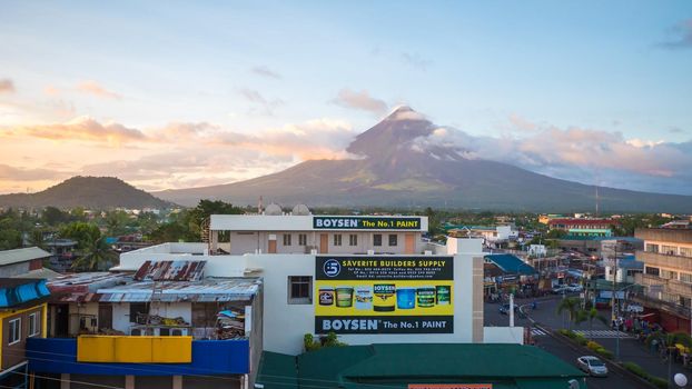LEGAZPI, PHILIPPINES - JANUARY 5, 2018: - Mount Mayon volcano looms over the city as daily life goes on.