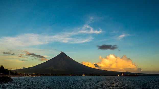 Silhouette Mayon Volcano is an active stratovolcano in the province of Albay in Bicol Region, on the island of Luzon in the Philippines. Renowned as the perfect cone because of its symmetric conical shape.