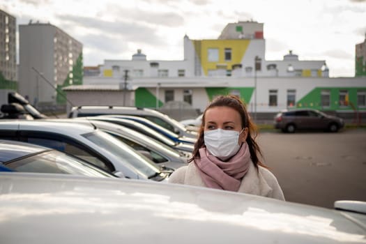 picture of a girl in a mask, on the street. isolated Covid-19 pandemic.