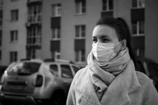 Shot of a girl in a mask, on the street. lockdown Covid-19 pandemic.