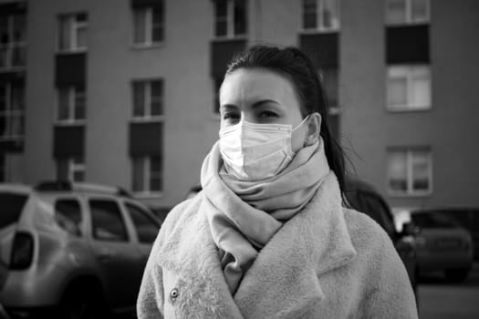 Shot of a girl in a mask, on the street. lockdown Covid-19 pandemic.