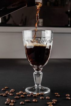 Alternative method of making coffee. coffeemaker is a manual pour-over style glass. Cofee brewing on black background.