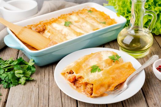 Cannelloni with filling of ground beef, tomatoes,