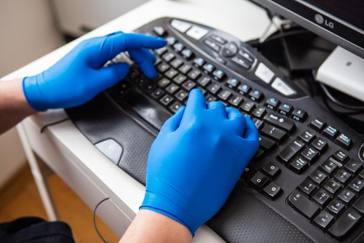 A doctor in blue gloves quickly collects data about a patient. The concept of healthcare and taking care of your health.
