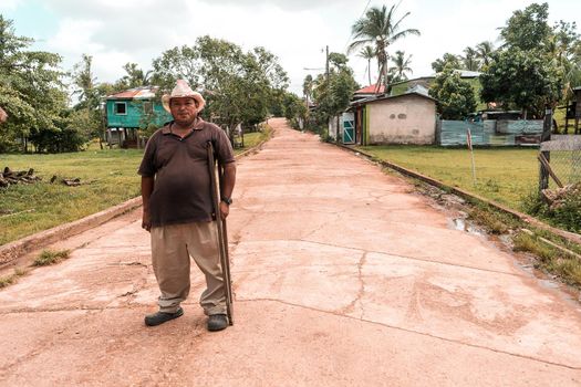 Mestizo indigenous man with crutches and hat in the caribbean of Nicaragua