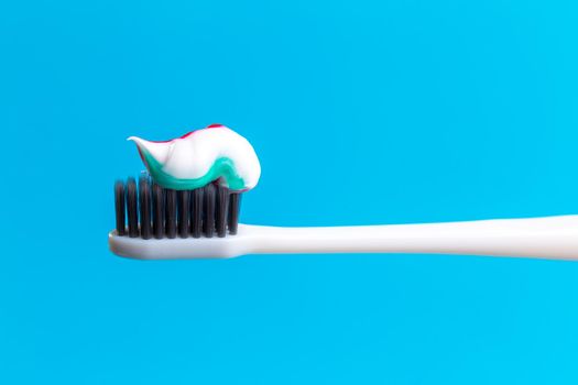 Toothbrush and toothpaste on blue. creative photo