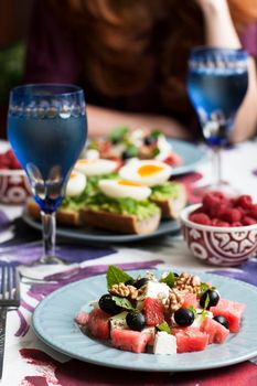 A light summer dinner for two: salad, boiled eggs, raspberries for dessert and white wine.