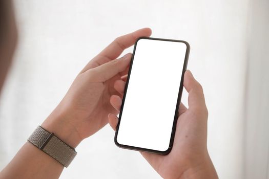 Woman hand holding smartphone with blank white screen
