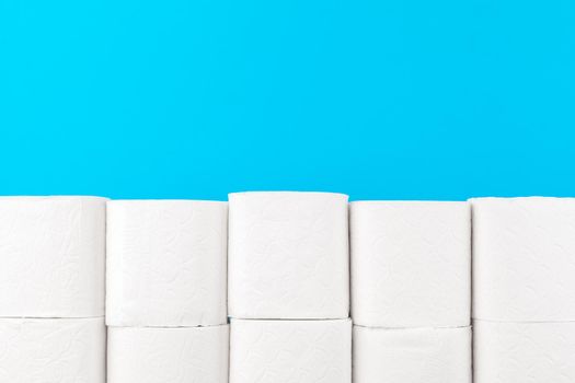 Toilet paper stack on bright blue background