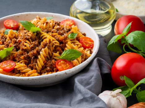 Bolognese pasta. Fusilli with tomato sauce, ground minced beef