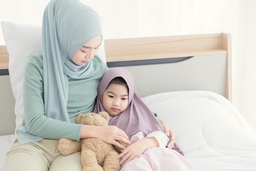 muslim mother consoling cry and depress little child from being bullied and hate to go to school.