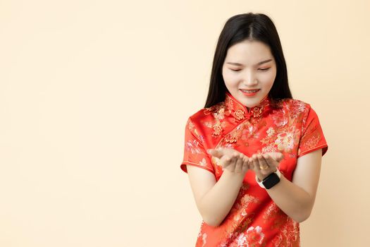 Chinese teen girl hand giving donation  posture dressing traditional dress with space for text.