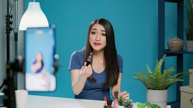 Beauty blogger recording product recommendation on camera