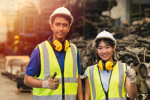 Portrait two Asian young man and women worker thumbs up couple friend team engineer working standing together happy smile to work in factory industry