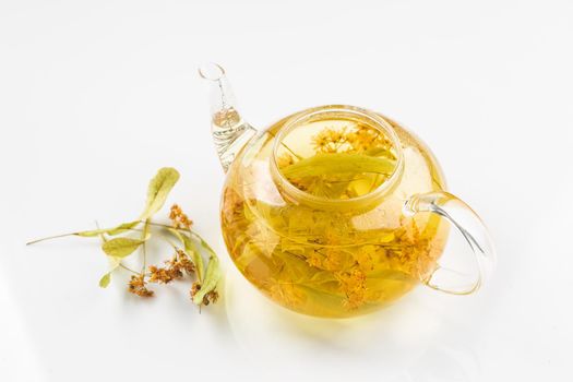 Linden or tilia tea in the transparent tea pot