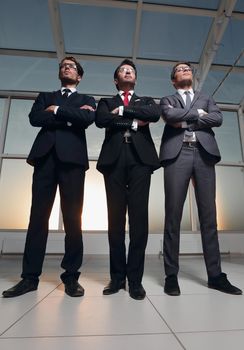 three confident businessmen look forward