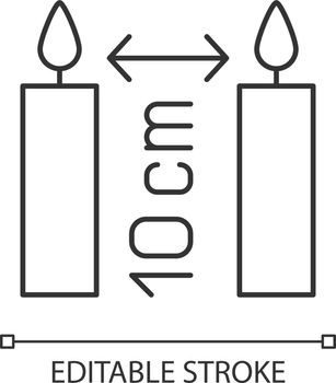 Distance between burning candles linear manual label icon