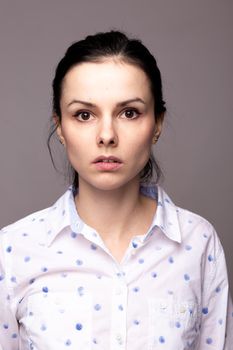 brunette woman in white polka dot shirt