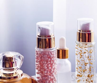 Skincare and make-up cosmetics, golden serum emulsion bottles and perfume, beauty product