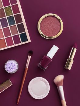 Beauty, make-up and cosmetics flatlay design with copyspace, cosmetic products and makeup tools on purple background, girly and feminine style