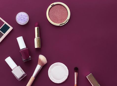 Beauty, make-up and cosmetics flatlay design with copyspace, cosmetic products and makeup tools on purple background, girly and feminine style