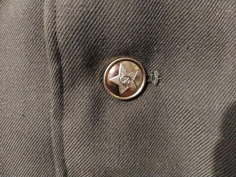 Button on the tunic of serviceman of internal troops