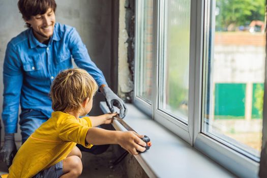 Father and son repair windows together. Repair the house yourself.
