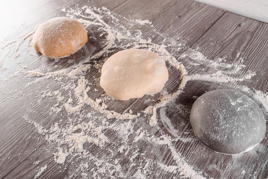 Dough ball with flour. Cooking pizza with italian white dough. Food blanks in restaurant