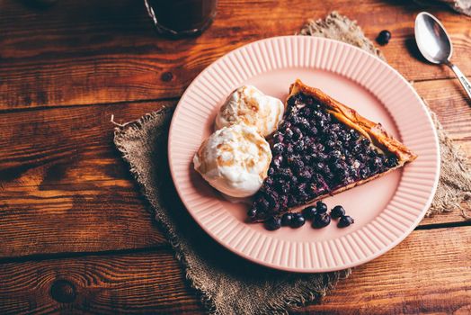 Slice of Serviceberry Pie and Two Scoops Of Vanilla Ice Cream