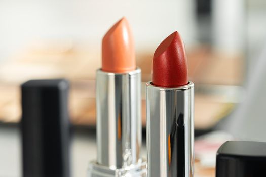 Pink and red lipsticks on vanity table