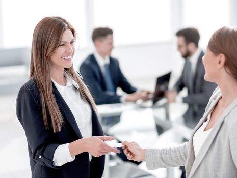 successful business woman gives her business card
